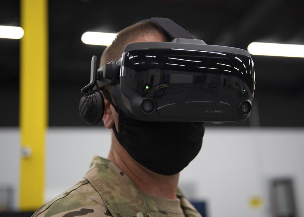 Person wearing a Valve Index PC VR headset and holding its controllers